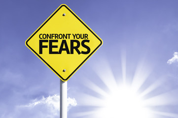 Confront your Fears road sign with sun background