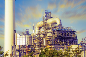 Fototapeta premium Oil refinery plant and industrial factory building construction from engineering technology and steel material such as steel structure, metal, valve control, pipe, pipeline for transport oil and gas.