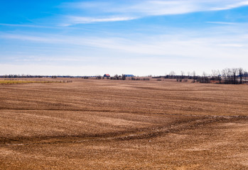 Fototapeta na wymiar Empty brown farm fields on sky.
