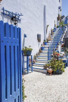 blue gates and white wall