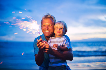 Father and son lighting fireworks