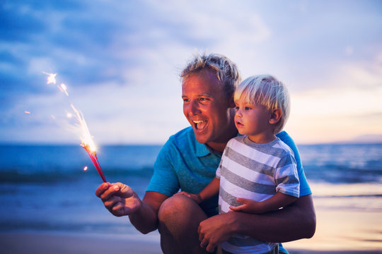 Father and son lighting fireworks