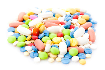 Pile of various colorful pills isolated on white  