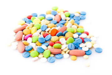 Pile of various colorful pills isolated on white  