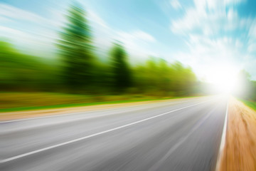 Asphalt road in motion blur on summer day.