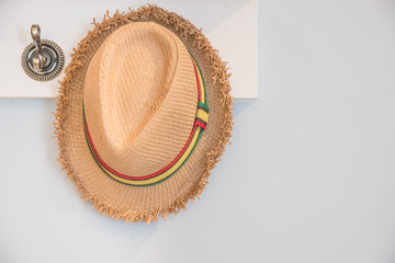 Female hat hanging on hotel wall