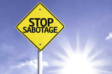 Stop Sabotage road sign with sun background