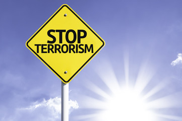 Stop Terrorism road sign with sun background