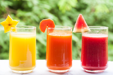Fruit and vegetable juice with green background