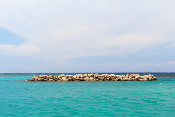 Background  sea blue sky white clouds breakwater