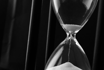 Sand running through the bulbs of an hourglass
