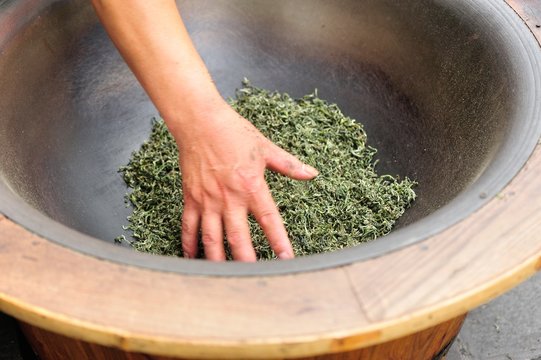 Stir Frying Tea Leaves In The Pan