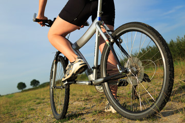 Fototapeta na wymiar Young woman on her bicycle in the countryside.