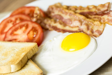 English Breakfast With Fried Egg, Bacon, Toast And Tomatoes