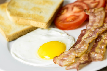English Breakfast With Fried Egg, Bacon, Toast And Tomatoes