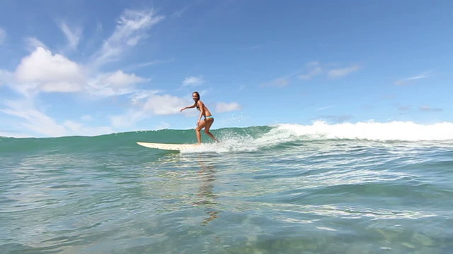 Slow Motion Woman Surfing Ocean Wave