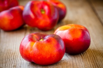 fresh flat nectarines on a wooden background