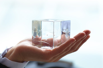 glass cube in the hand