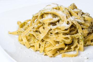 pasta with pesto on white plate