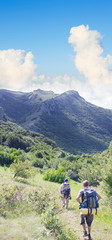 Fototapeta premium A group of tourists walking on a mountain road