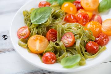 Close-up of boiled tagliatelle and roasted tomatoes, studio shot