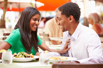 Fototapeta na wymiar Couple Enjoying Lunch In Outdoor Restaurant