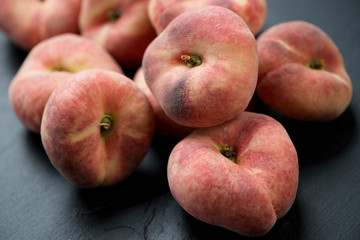 Fototapeta na wymiar Close-up of ripe saturn peaches, horizontal shot