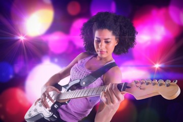 Composite image of pretty girl playing guitar