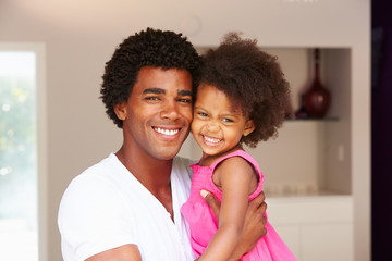 Obraz premium Dad Cuddling Daughter At Home