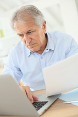 Senior man working on laptop computer