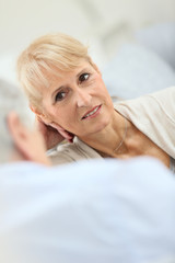 Fototapeta premium Senior couple having a conversation, sitting in sofa