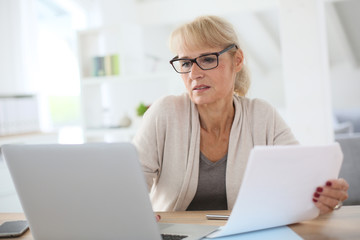 Senior woman working on laptop computer