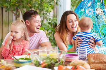 Family Enjoying Outdoor Meal At Home