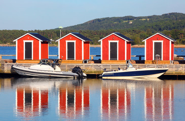 Fototapeta na wymiar Wooden fishing huts along the bridge in Båstad