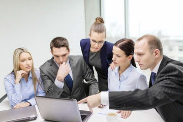 business team with laptop having discussion