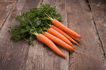 fresh carrot bunch on grungy wooden background