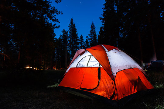 Campsite with illuminated tent