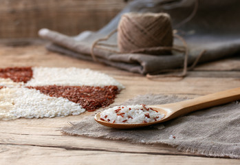 white and red rice in a wooden spoon