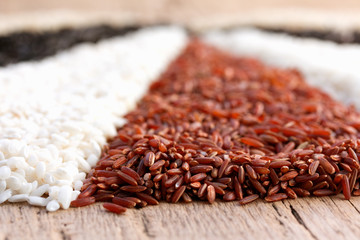 different types of rice on the old wooden table
