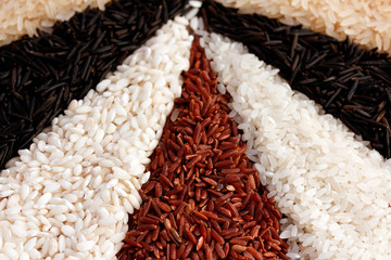 different types of rice on the old wooden table