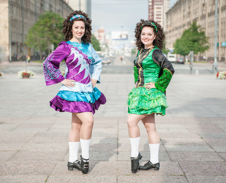 Two women in irish dance dresses posing