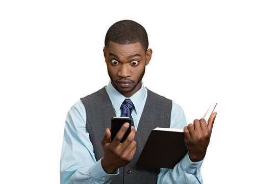 Shoked man with phone holding book, white background 