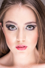 gorgeous young woman's face with makeup
