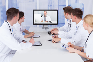 Doctors Having Video Conference Meeting In Hospital