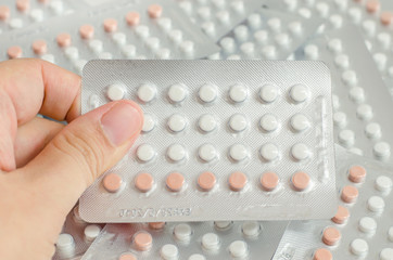 woman hand holding contraceptive pills