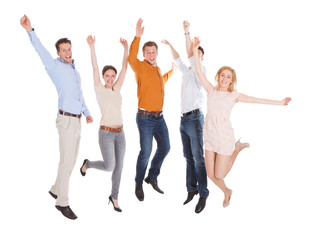 Fototapeta premium Excited Friends Jumping Over White Background