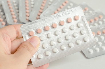 woman hand holding contraceptive pills