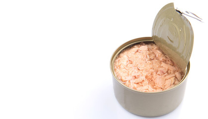 Pieces of tuna fish in a tin can over white background
