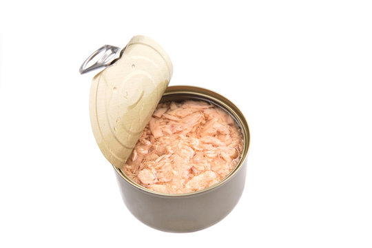 Pieces of tuna fish in a tin can over white background