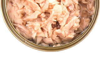 Pieces of tuna fish in a tin can over white background